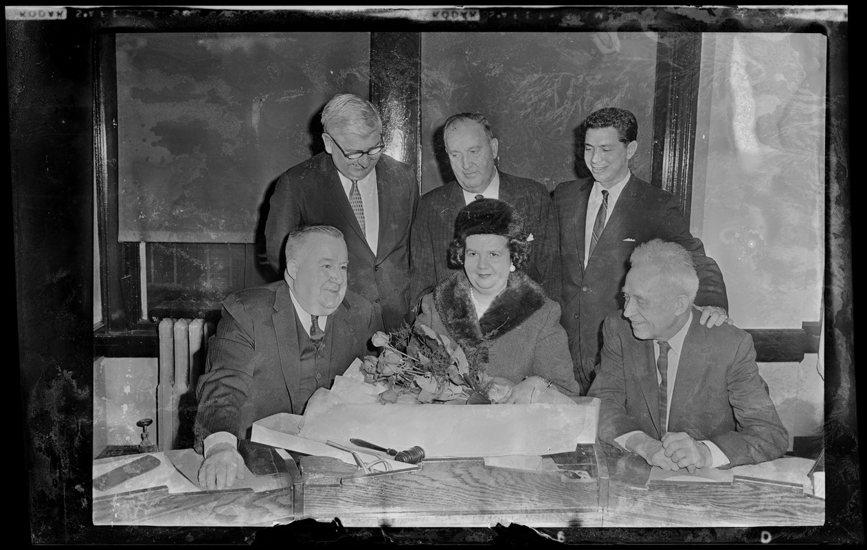 Newly elected chairman of the Boston School Committee admires beautiful red roses sent to her after she won the nomination of the chairmanship of the Boston School Committee, surrounded by her members. Dr. Fred Gillis, Mrs. Louise Day Hicks, Chairwoman, Joe Lee, (rear) Arthur Gartland, William O'Connor, and Thomas Eisenstadt