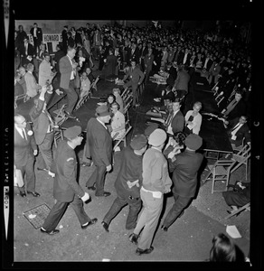 Police officers assist woman having a seizure during President Lyndon Johnson's rally in Post Office Square