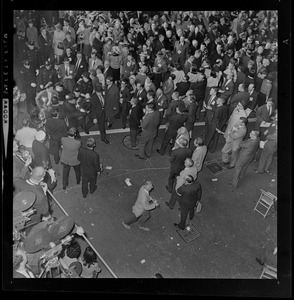 Police officers assist woman having a seizure during President Lyndon Johnson's rally in Post Office Square