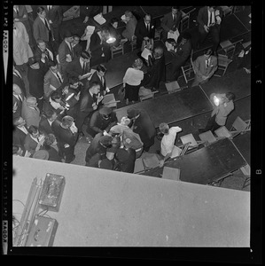 Police officers assist woman having a seizure during President Lyndon Johnson's rally in Post Office Square