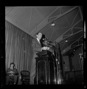 Unidentified man addressing audience at Tufts University