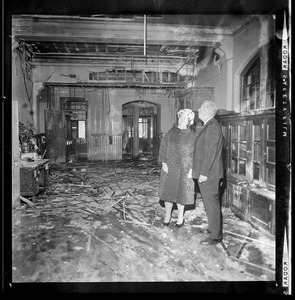 School Committee Chairman Louise Day Hicks and William Ohrenberger view interior of Hyde School damaged by fire