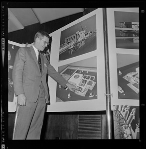 David B. Stone, President of New England Aquarium, pointing at architect's rendering of the new aquarium