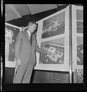 David B. Stone, President of New England Aquarium, pointing at architect's rendering of the new aquarium