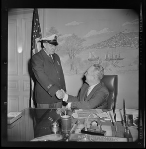 Mayor John Collins in his office with unidentified police officer