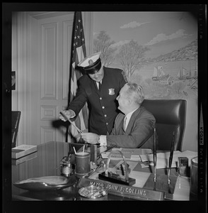 Mayor John Collins in his office with unidentified police officer