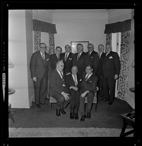 Group portrait from party for Harold G. Kern, with Kern and Mark Francis Collins seated on right