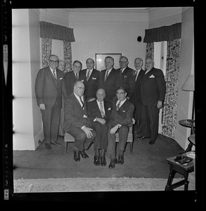 Group portrait from party for Harold G. Kern, with Kern and Mark Francis Collins seated on right