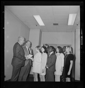 Boston police and school department officials salute seven young individuals for meritorious acts by presenting them with savings bonds. From left, School Supt. William Ohrenberger, Police Comr. Edmund McNamara, Ellen Bolingbroke, Wanda Woodworth, Gary Galinos, James Cody, Judith Alman, Edward Lewis, and Rosemary Dorr