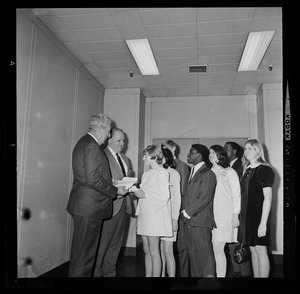 Boston police and school department officials salute seven young individuals for meritorious acts by presenting them with savings bonds. From left, School Supt. William Ohrenberger, Police Comr. Edmund McNamara, Ellen Bolingbroke, Wanda Woodworth, Gary Galinos, James Cody, Judith Alman, Edward Lewis, and Rosemary Dorr