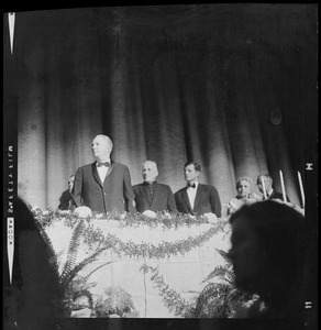 Boston Mayor John F. Collins, Richard Cardinal Cushing, and Sen. Edward M. Kennedy stand for national anthem at start of testimonial dinner honoring the Mayor