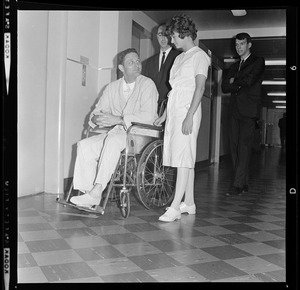 Sen. Birch Bayh of Indiana looks up at nurse Beverly Vogel before continuing down corridor of Cooley Dickinson Hospital, Northampton, to meet and discuss plane crash with newsmen