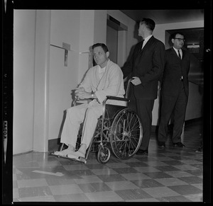 Dr. David Jackson pushing Sen. Birch Bayh in a wheelchair