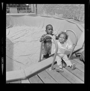 Two children at empty above-ground pool