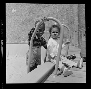 Two children at empty above-ground pool