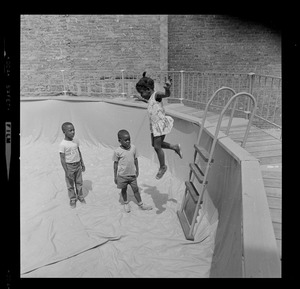 Three children at empty above-ground pool