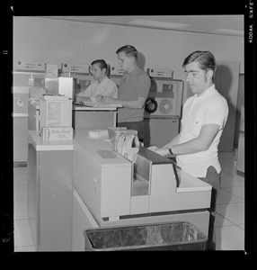Three men working with computers