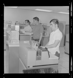 Three men working with computers