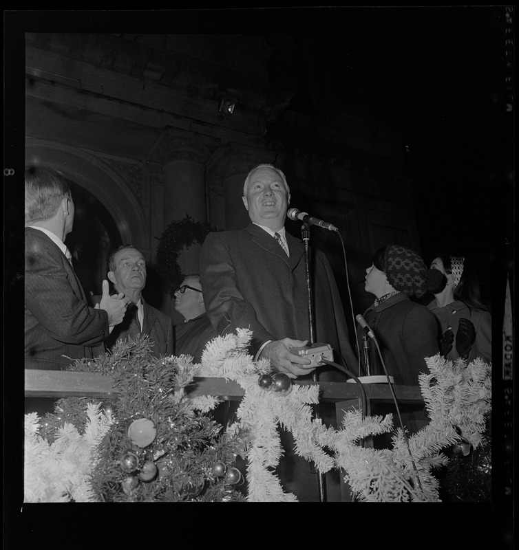 Mayor John F. Collins with switch to illuminate Christmas lights at City Hall