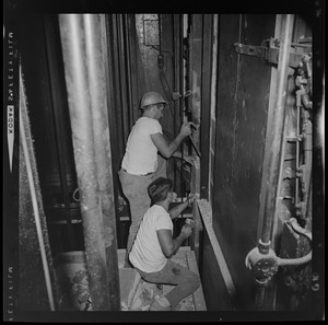 Two construction workers working