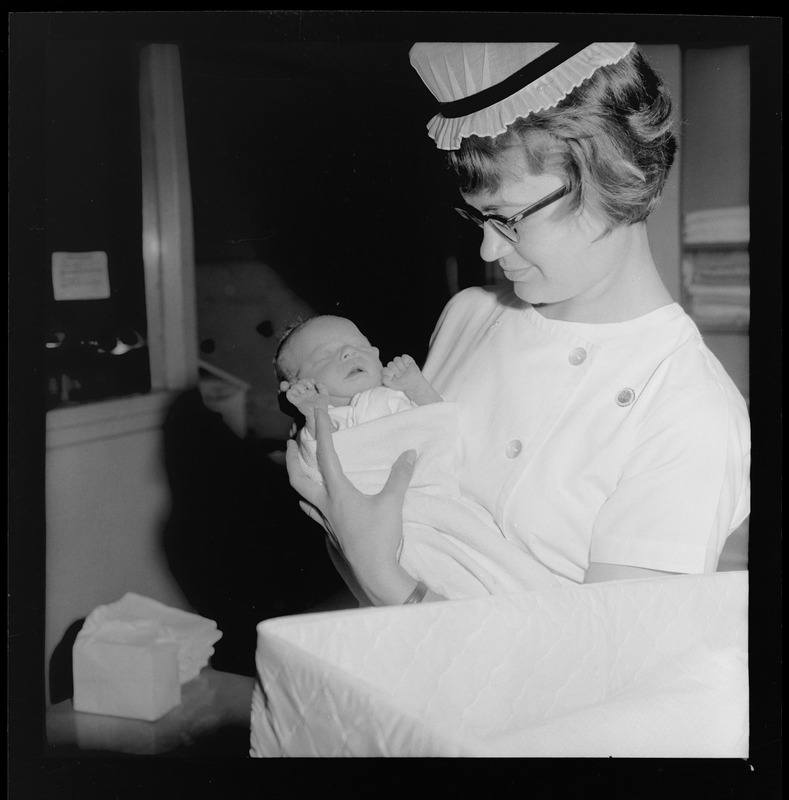 Abandoned baby girl in arms of Nurse Madeline Kaplett at Boston City Hospital where her condition is good