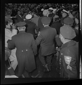 Dr. Benjamin Spock surrounded by protesters outside the Federal Building in Boston after his arraignment on charges of aiding draft resisters