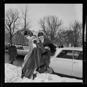 Unidentified woman and Dr. Benjamin Spock arriving at Arlington Street Church for anti-draft rally