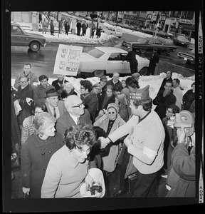 Member of an organization known as "Vets for Peace in Vietnam," steps out of picket line to shake hands with Dr. Benjamin Spock after the famed pediatrician's indictment on federal chargers of aiding draft resisters