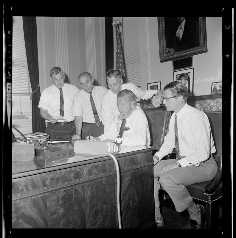 Gov. John A. Volpe, on phone at the State House, checks conditions in Springfield as aides (L. to R.) A. DeFalco, J. Tauro, T. Regan, and Lt. Gov. E. Richardson stand by