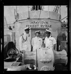 Three crew members on the ship deck of the Italian missile destroyer Impavido
