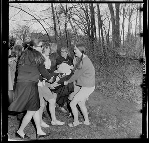 Wellesley College students carrying a student, possibly a Harvard infiltrator, to Lake Waban after the Hoop Roll