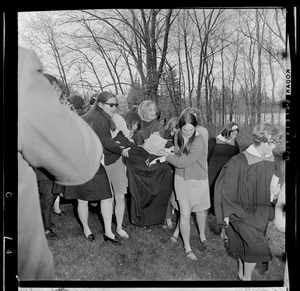 Wellesley College students carrying a student, possibly a Harvard infiltrator, to Lake Waban after the Hoop Roll
