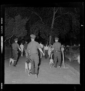 Police with dogs patrolling Boston Common during curfew