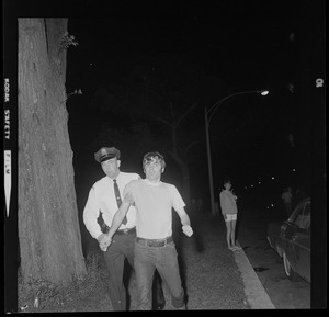 Police officer arresting a man during curfew protest at Boston Common