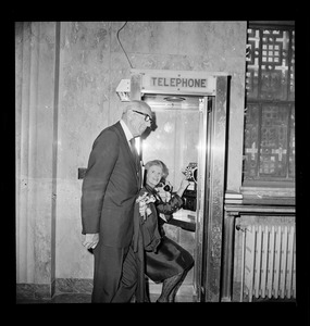 Dr. and Mrs. Benjamin Spock speak on telephone with their grandchildren on opening day of trial