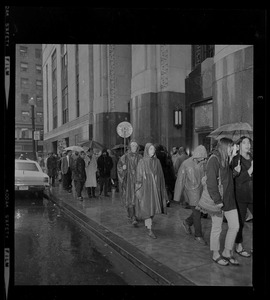 Pickets sympathetic with Dr. Spock and other defendants march outside Boston's Federal Building