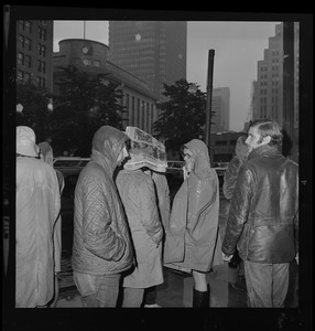 Pickets sympathetic with Dr. Spock and other defendants march outside Boston's Federal Building