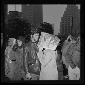 Pickets sympathetic with Dr. Spock and other defendants march outside Boston's Federal Building