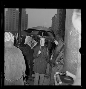 Pickets sympathetic with Dr. Spock and other defendants march outside Boston's Federal Building