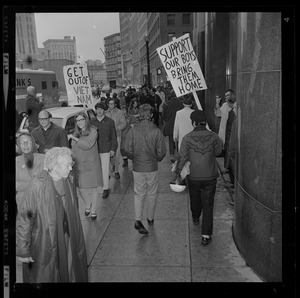 Pickets sympathetic with Dr. Spock and other defendants march outside Boston's Federal Building