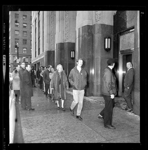 Pickets sympathetic with Dr. Spock and other defendants march outside Boston's Federal Building