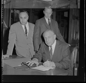 Shown signing new welfare amendment is Judge Robert G. Wilson Jr., Rep. David Locke of Wellesley, and Joseph S. Dow, Overseer of Public Welfare who signed as a taxpayer