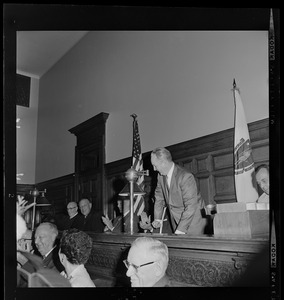 Judge John V. Mahoney, Judge Robert G. Wilson, Jr., and Sen. Leverett Saltonstall watch as Boston Mayor John Collins addresses courtroom during celebration of Wilson's 25th anniversary as member of Suffolk Probate Court bench