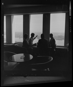 People drinking coffee in lounge overlooking Boston Harbor in the State Street Bank Building