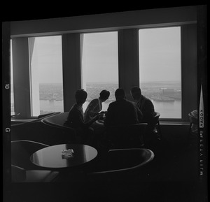 People drinking coffee in lounge overlooking Boston Harbor in the State Street Bank Building