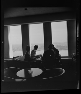 People drinking coffee in lounge overlooking Boston Harbor in the State Street Bank Building