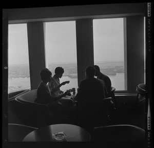 People drinking coffee in lounge overlooking Boston Harbor in the State Street Bank Building