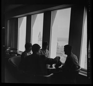 People drinking coffee in lounge overlooking Boston Harbor in the State Street Bank Building