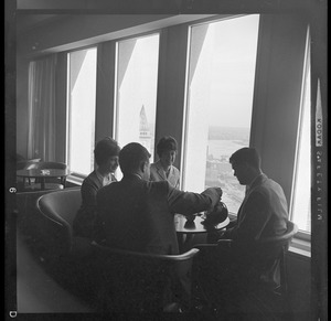 People drinking coffee in lounge overlooking Boston Harbor in the State Street Bank Building