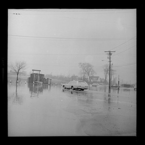 Car on street flooded during northeast storm